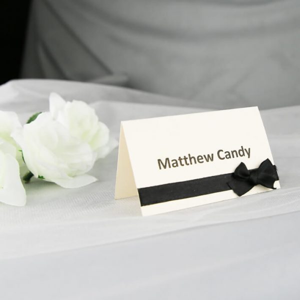 PLACAR129 cream individual place card printed in black with black ribbon and bow
