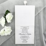 WEDINV30 inside of floral embossed white wedding invitation with diamante and tassle