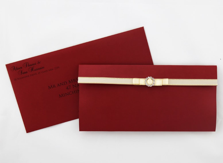 WEDINV108 front of Maroon Red and Bright Gold Wedding Invitation Pouch with cream and gold ribbon and Diamante with envelope