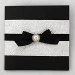 WEDINV126 Black and ivory wedding invitation with embossed paper black ribbon bow and pearl
