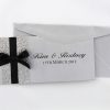 WEDINV26 Silver pebbles and black ribbon and bow wedding invitation with back of envelope