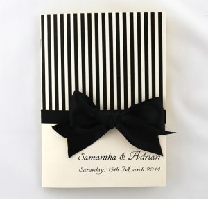 WEDINV141 cream metallic with black stripes and bow cermony book front