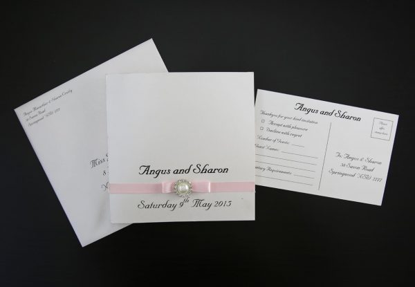 WEDINV01 pink ribbon and bow with pearl ivory wedding invitation with envelope and rsvp card