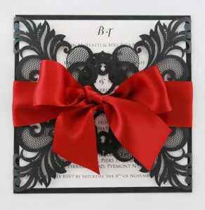 WEDINV130 black lasercut invitation with red ribbon and white insert