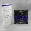 Black laser cut invitation with purple ribbon and white insert white and purple tri fold table menus