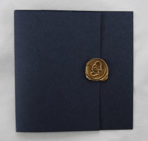 wedding invitation seals gold on a navy blue invitation