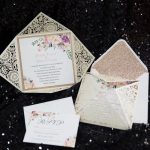 WEDINV148 Ivory lasercut wedding invitation with floral insert and white envelope with gold glitter liner set