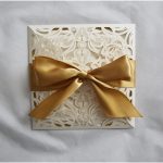 WEDINV187 Ivory lasecut wedding invitation with gold ribbon