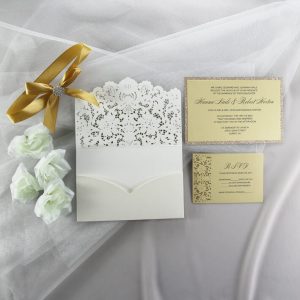 WEDINV201 inside of Ivory pocketfold lasercut wedding invitation with gold ribbon diamante and gold glitter